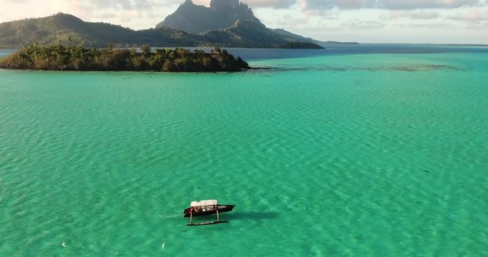 Drone Shot of a Boat Crossing the Ocean Revealing the View of Bora Bora