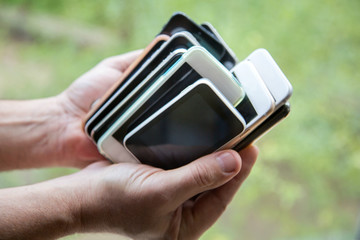 Collection of old, used and broken cell phones