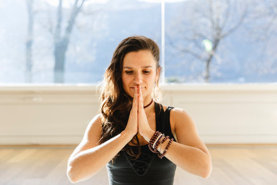 Young woman meditating at home