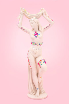 White statue of a woman decorated with shiny stickers.