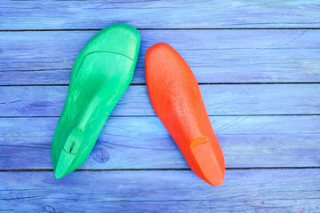 A last on wooden background. Wooden form for shoe making.