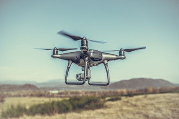 Drone in flight in the countryside. Drone in the air.