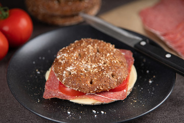 Round rye bun with cheese and salami