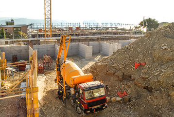 Excavators machine on a construction site assembly a huge mold with reinforcement mesh for concreting