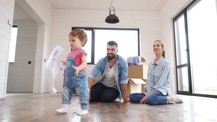 The young family is in their new summer house, where they are making plans to renovate the house.