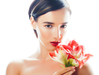 Fototapeta na wymiar young pretty brunette real woman with red flower amaryllis closeup isolated on white background. Fancy fashion makeup, bright lipstick, creative Ombre manicured nails