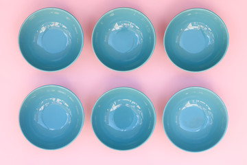 Blue dishes on pink table.