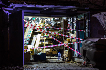 fenced garage at the crime scene, background blurred with bokeh effect