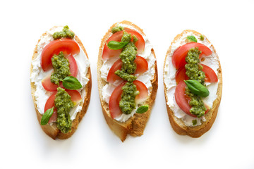 Toast with soft mascarpone cheese, tomatoes and fresh basil pesto