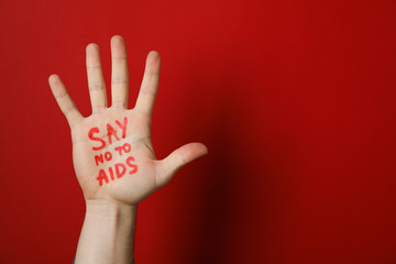 Hand with inscription Say no to AIDS on red background, copy space