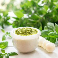 Green italian homemade sauce pesto in stone pounder
