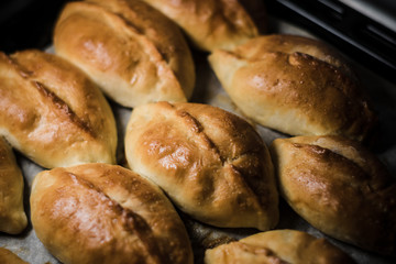 Toasted pies on parchment paper and everything on a tray
