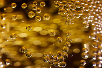 Bubbles in a glass with champagne close-up. Background. Texture