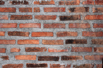 Naklejka premium Red brick and cement wall as a background