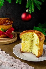 Panettone - Italian tradition festive baking. Wooden background with fir tree. Christmas.