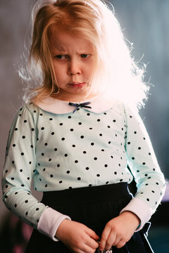 Cute little blonde girl with a hurt look