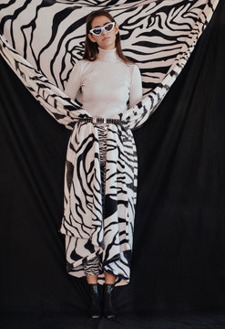 Trendy female wrapped in zebra cloth