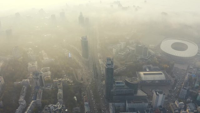 Aerial view of very dense morning fog in city Kiev. Smog or fog in big city. Problem of pollution of the environment. Olypmic stadium 4k