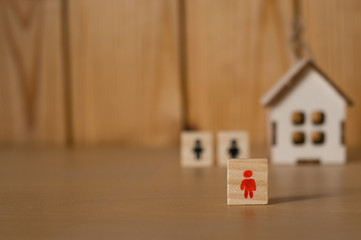 Wooden figures on wooden background. Homeless concept. Real estate concept 