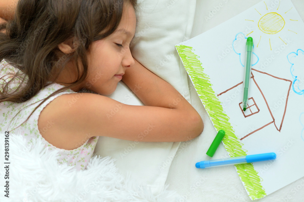 Sticker cute little girl sleeping in bed after drawing