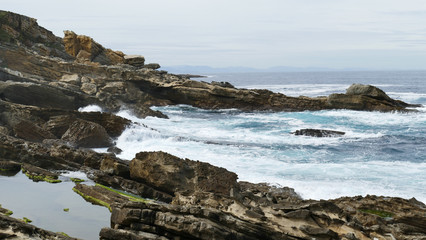 Coast of the sea with waves crashing on the rocks