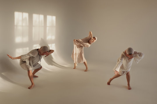 Women covering faces while dancing