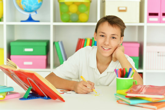 Close up portrait of smiling teen boy drawing