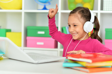 Close up portrait of emotional cute girl using laptop