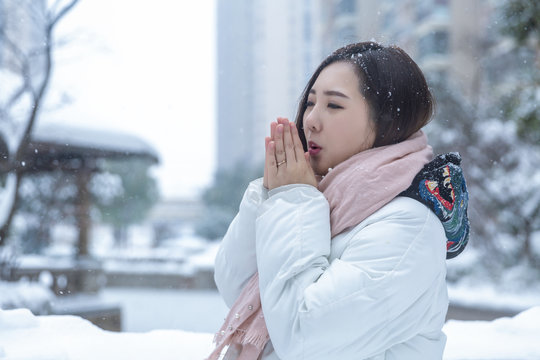Girl playing with snow in park