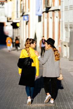 Stylish young women walking in the street