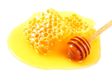 Honeycomb with honey dipper and honey isolated on white background