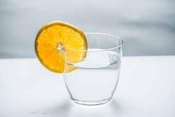 Glass of pure water with citrus fruit