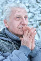 Close up portrait of senior man praying