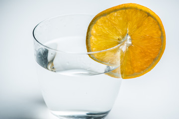 Glass of pure water with citrus fruit