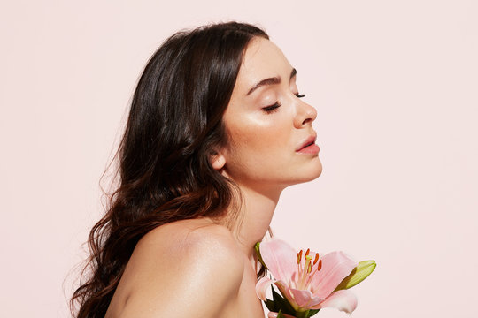 Portrait over pink nude woman with flower