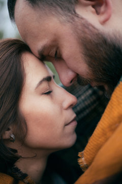 close portrait of a couple in love wrapped in a blanket