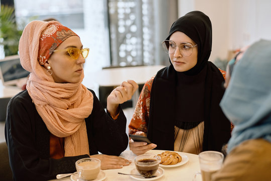 Group Of Elegant Eastern Women in Cafe