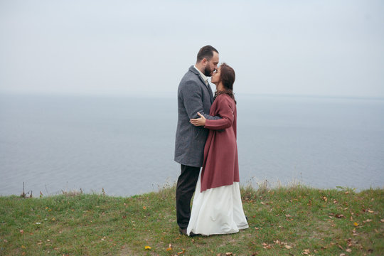 wedding couple standing and hugging against the background of the sea