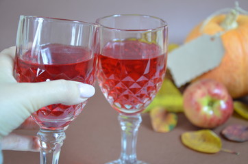 Thanksgiving Day. Pumpkin, pumpkin with autumn leaves and apples. Autumn harvest on a brown background.   set table for celebration. fork and knife still life with bottle glass of red wine