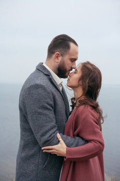 portrait of a wedding couple standing and hugging against the background of the sea