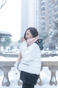 Girl playing with snow in park