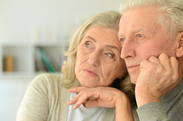 Close up portrait of sad senior couple