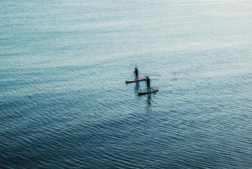 Two SUP Stand Up Paddle Board with Kayak on sea