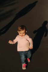 Adorable little girl walk in the parl in october. Cute ten month baby walk. Beautiful happy girl. Autumn mood