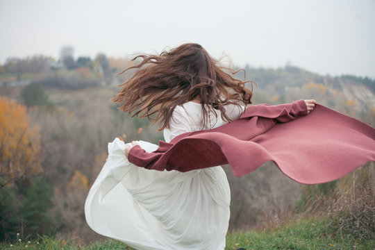 girl's hair and dress develop in the wind