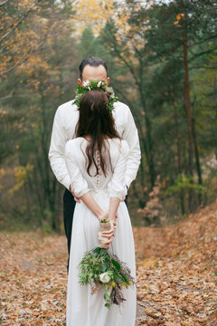hands of the bride on the shoulders of the bride photo behind