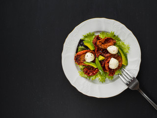 salad made from dried tomatoes, pe-tsai, avocado, and mozzarella cheese.