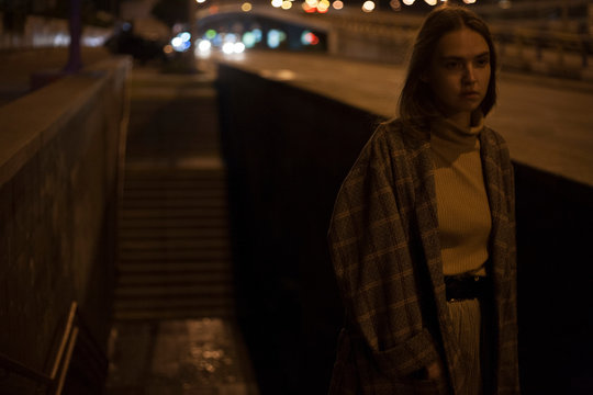 cinematic portrait of a girl at night on the background of the underpass