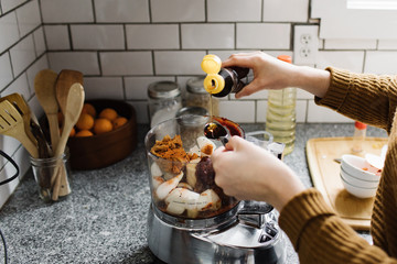 Woman Mixing Ingredients in a Food Processor
