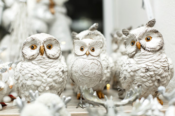 holiday christmas decoration. Shelf with figures of toy white owls. Little things that create a Christmas mood.